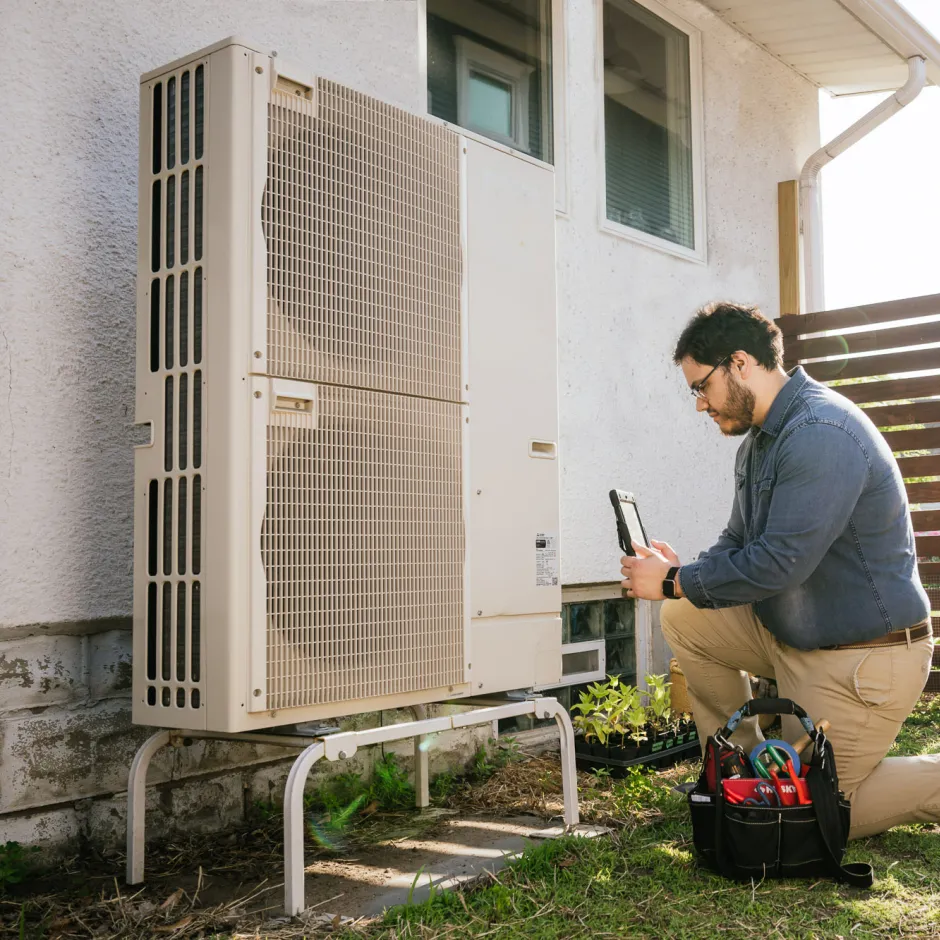 A contractor servicing a heat pump 